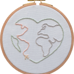 Love World hand embroidery design in wooden hoop